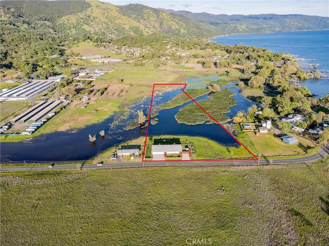 birds eye view of property featuring a water and mountain view