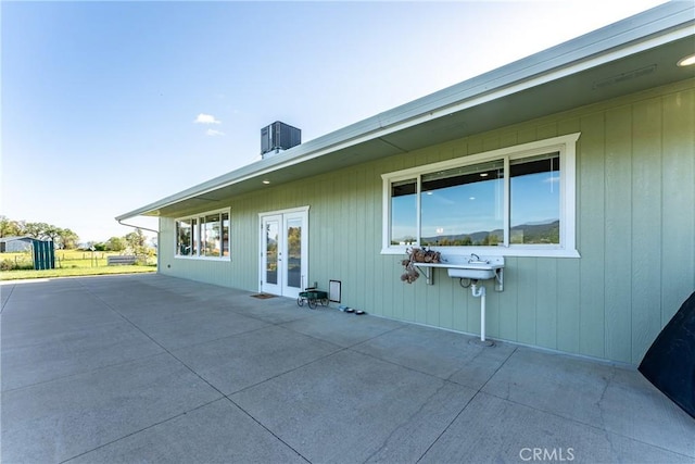 back of house featuring central AC unit, a patio, and french doors