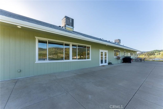 rear view of property with french doors and a patio