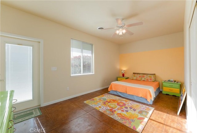 bedroom featuring baseboards, tile patterned flooring, and ceiling fan