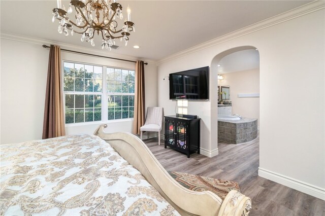 bedroom featuring wood finished floors, arched walkways, crown molding, baseboards, and a notable chandelier