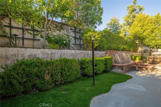 view of yard with fence and a patio