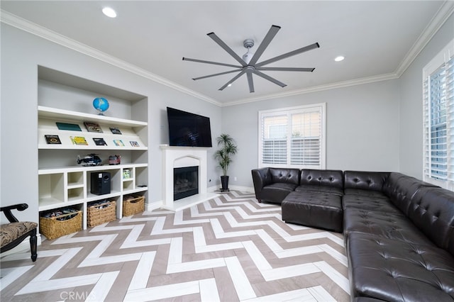 living room featuring built in shelves, ceiling fan, a fireplace with raised hearth, and plenty of natural light