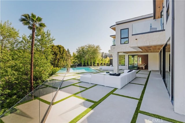 outdoor pool with an outdoor hangout area and a patio