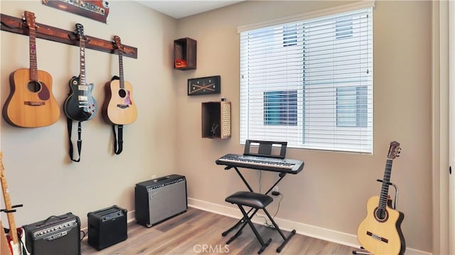 misc room featuring baseboards and wood finished floors