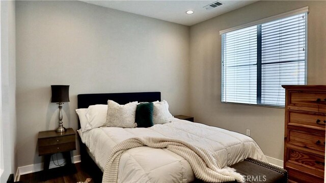 bedroom with dark wood-style floors, baseboards, visible vents, and recessed lighting