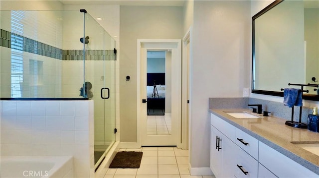 ensuite bathroom with a bath, tile patterned floors, a sink, double vanity, and a shower stall