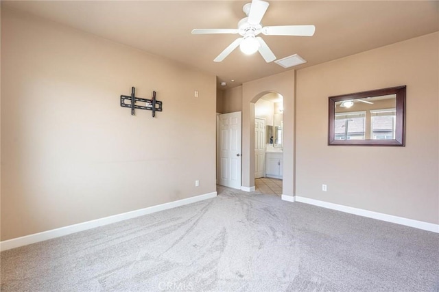 25102 Goodrich Ct, Stevenson Ranch, CA 91381 - spare room with arched walkways, a ceiling fan, baseboards, and light carpet