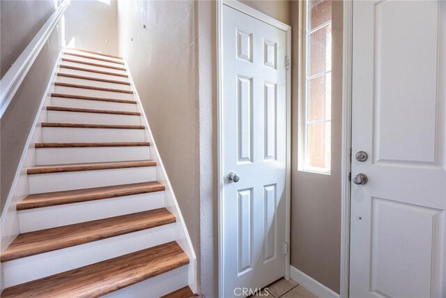 25102 Goodrich Ct, Stevenson Ranch, CA 91381 - stairway with baseboards and tile patterned flooring
