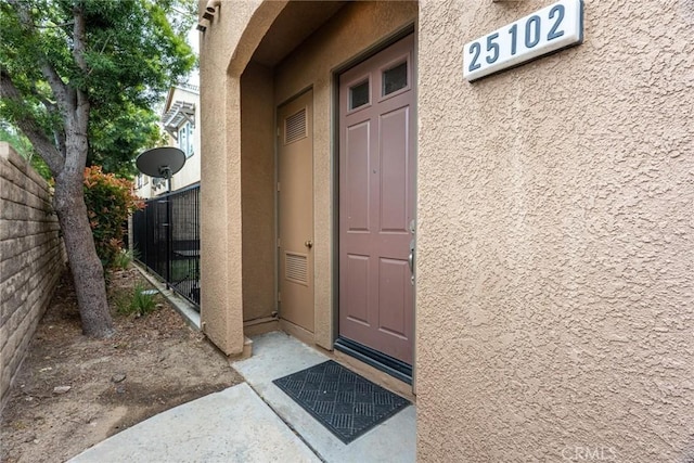 25102 Goodrich Ct, Stevenson Ranch, CA 91381 - property entrance with stucco siding and fence