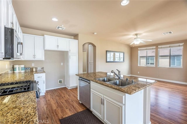 25102 Goodrich Ct, Stevenson Ranch, CA 91381 - kitchen with wood finished floors, a sink, arched walkways, appliances with stainless steel finishes, and visible vents