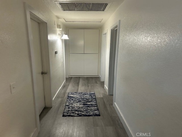 1508 Sunrise Rd, Barstow, CA 92311 - hallway featuring wood finished floors, baseboards, and a textured wall