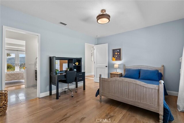 25174 Mulholland Hwy, Calabasas, CA 91302 - bedroom with a desk, french doors, and light wood finished floors