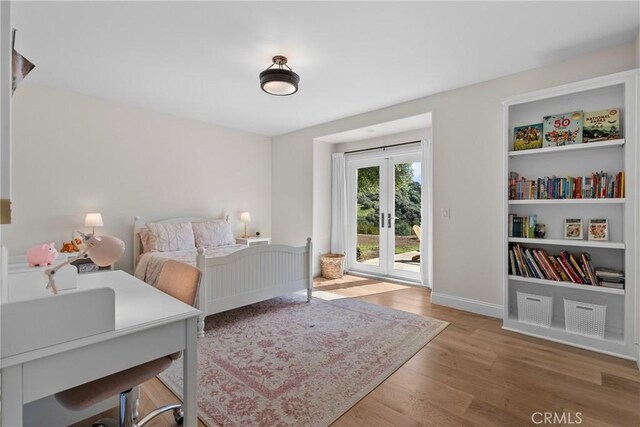 25174 Mulholland Hwy, Calabasas, CA 91302 - bedroom featuring french doors, access to exterior, wood finished floors, and baseboards