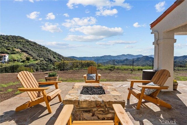 25174 Mulholland Hwy, Calabasas, CA 91302 - fenced backyard featuring a mountain view, an outdoor fire pit, and a patio