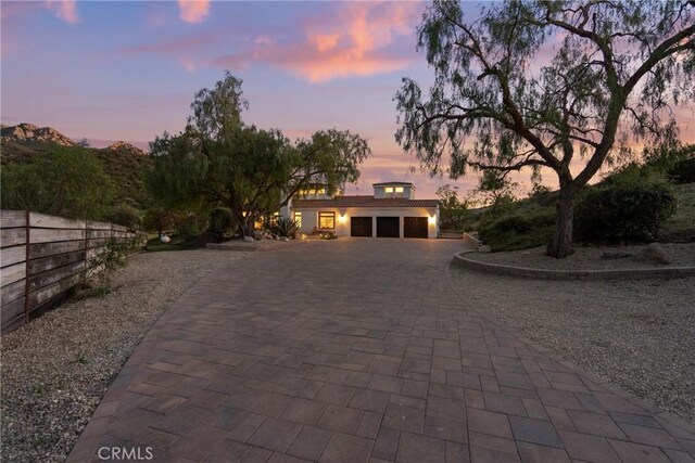 25174 Mulholland Hwy, Calabasas, CA 91302 - view of front of house with a garage and decorative driveway