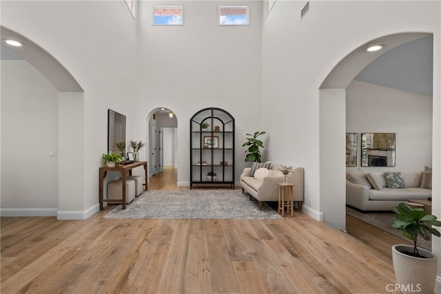25174 Mulholland Hwy, Calabasas, CA 91302 - foyer with a high ceiling, wood finished floors, baseboards, and arched walkways