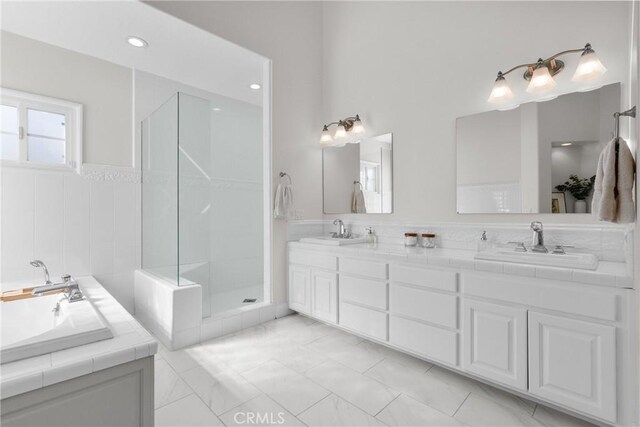 25174 Mulholland Hwy, Calabasas, CA 91302 - full bathroom featuring double vanity, a shower stall, a wainscoted wall, marble finish floors, and a bath