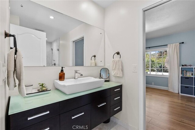 25174 Mulholland Hwy, Calabasas, CA 91302 - full bathroom featuring vanity, baseboards, wood finished floors, recessed lighting, and a shower