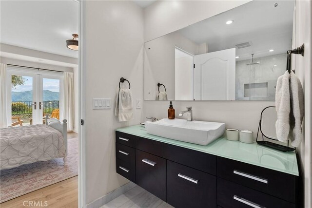 25174 Mulholland Hwy, Calabasas, CA 91302 - ensuite bathroom featuring double vanity, french doors, baseboards, recessed lighting, and a shower