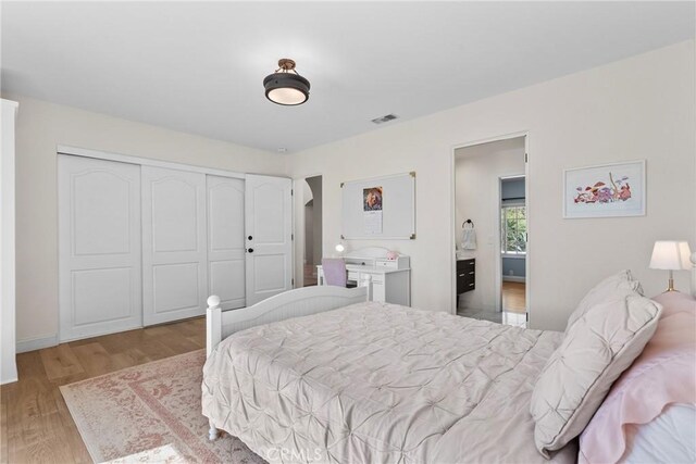 25174 Mulholland Hwy, Calabasas, CA 91302 - bedroom with light wood-style floors, a closet, and baseboards