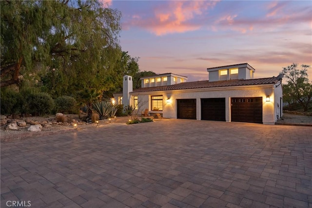 25174 Mulholland Hwy, Calabasas, CA 91302 - view of front of home featuring a garage, a tile roof, decorative driveway, and stucco siding