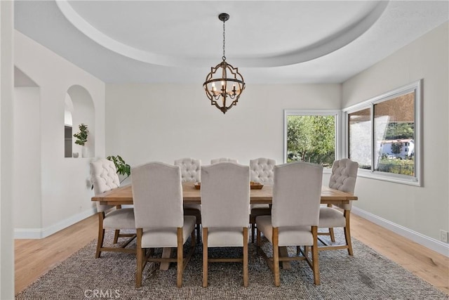 25174 Mulholland Hwy, Calabasas, CA 91302 - dining space with a chandelier, light wood-style flooring, baseboards, and a tray ceiling