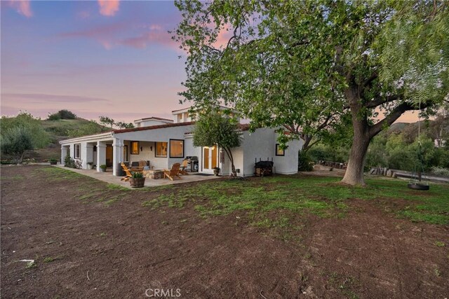 25174 Mulholland Hwy, Calabasas, CA 91302 - back of property featuring a patio area and stucco siding