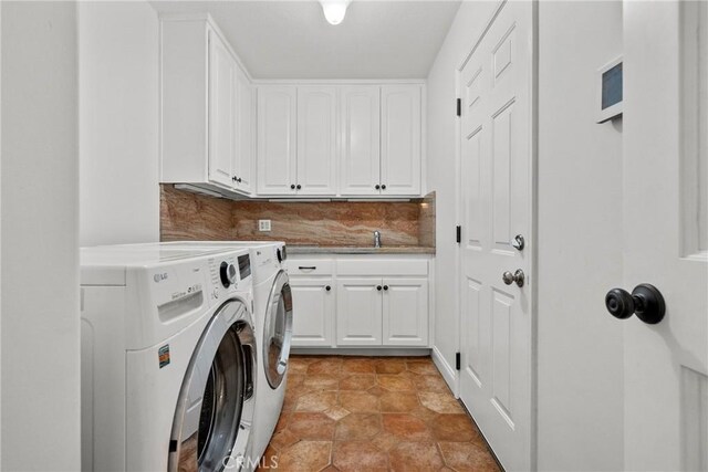25174 Mulholland Hwy, Calabasas, CA 91302 - washroom featuring washing machine and clothes dryer, cabinet space, and light tile patterned floors