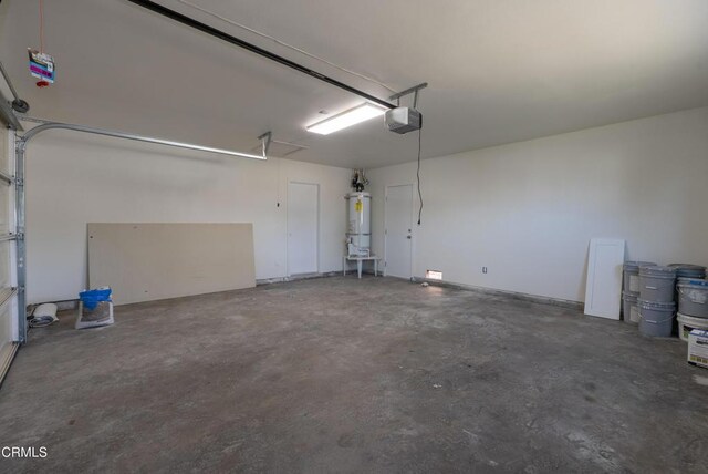 8751 Odessa Ave, North Hills, CA 91343 - garage featuring a garage door opener and water heater