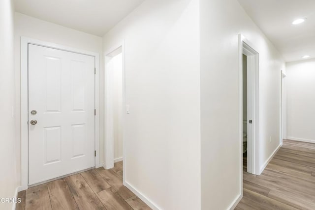 8751 Odessa Ave, North Hills, CA 91343 - corridor with light wood-style floors and recessed lighting