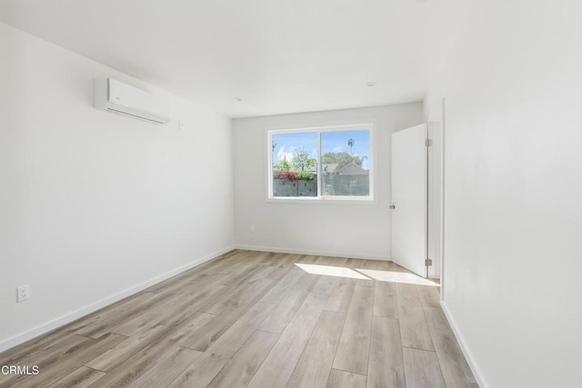 8751 Odessa Ave, North Hills, CA 91343 - unfurnished room featuring an AC wall unit and light wood-type flooring