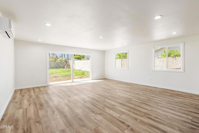 8751 Odessa Ave, North Hills, CA 91343 - spare room with light wood-type flooring, an AC wall unit, and recessed lighting