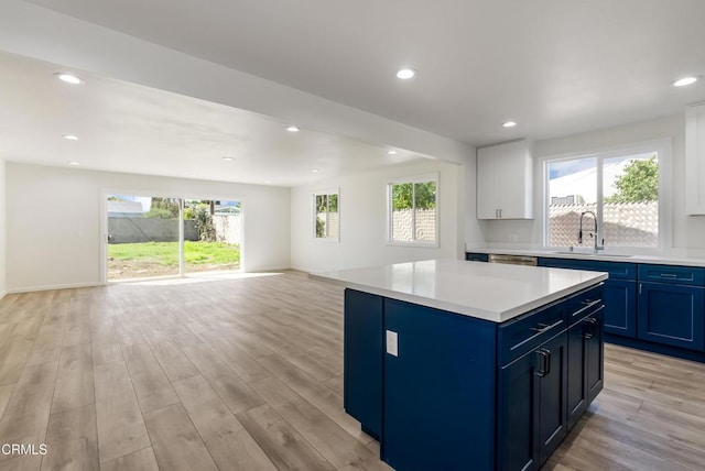 8751 Odessa Ave, North Hills, CA 91343 - kitchen featuring blue cabinetry, open floor plan, light countertops, light wood-style flooring, and recessed lighting