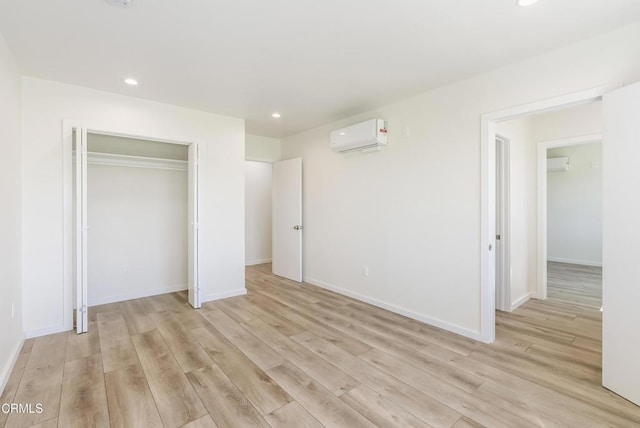 8751 Odessa Ave, North Hills, CA 91343 - unfurnished bedroom featuring a wall mounted air conditioner, light wood-style floors, recessed lighting, and a closet
