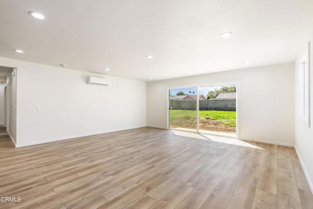 8751 Odessa Ave, North Hills, CA 91343 - spare room with light wood-style floors, a wall mounted AC, and recessed lighting