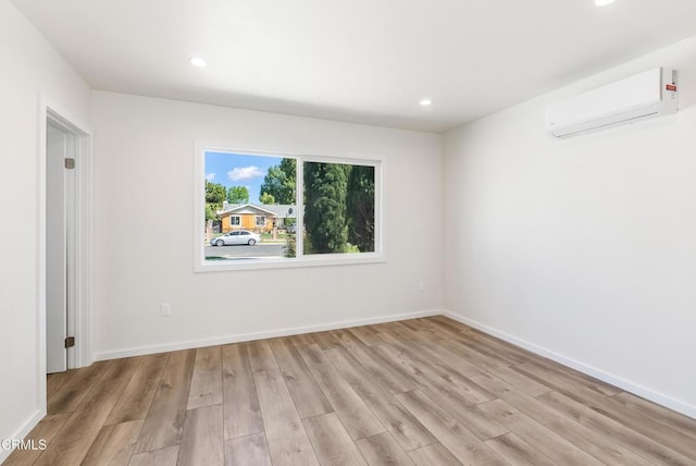 8751 Odessa Ave, North Hills, CA 91343 - empty room featuring a wall unit AC, light wood-style floors, and recessed lighting