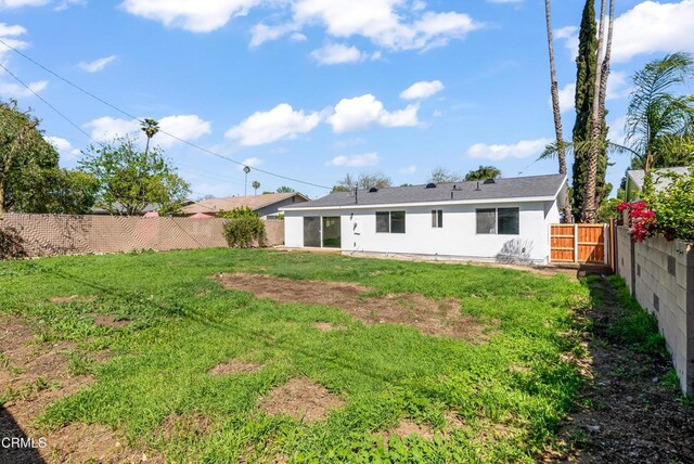8751 Odessa Ave, North Hills, CA 91343 - back of house with a fenced backyard, stucco siding, and a gate