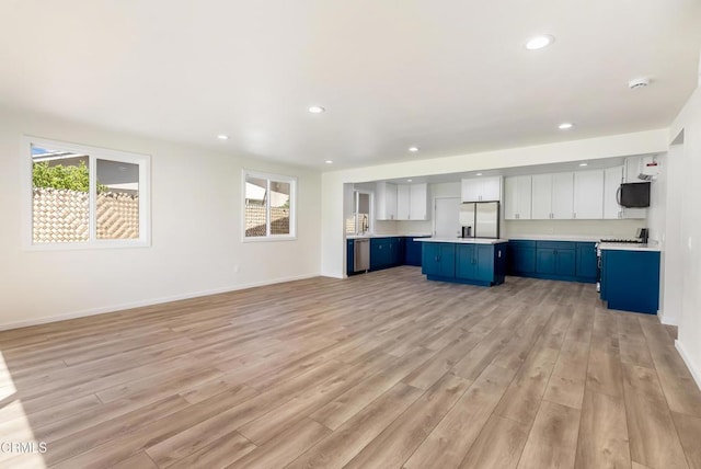 8751 Odessa Ave, North Hills, CA 91343 - unfurnished living room featuring light wood-style flooring and recessed lighting