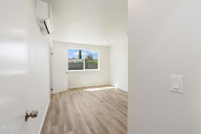 8751 Odessa Ave, North Hills, CA 91343 - unfurnished room featuring a wall mounted air conditioner, light wood-type flooring, and recessed lighting