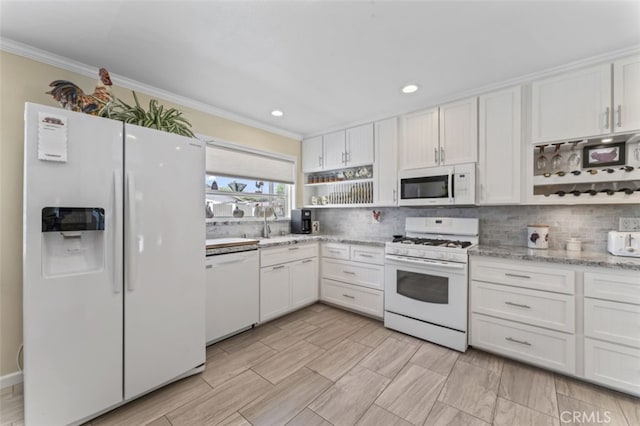 kitchen with white cabinetry, ornamental molding, open shelves, and white appliances