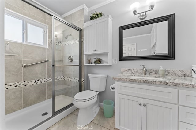 bathroom with tile patterned flooring, toilet, vanity, crown molding, and a stall shower