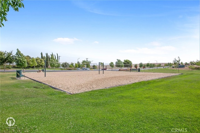 view of property's community with volleyball court and a lawn