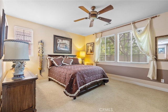 bedroom featuring visible vents, baseboards, carpet flooring, and multiple windows