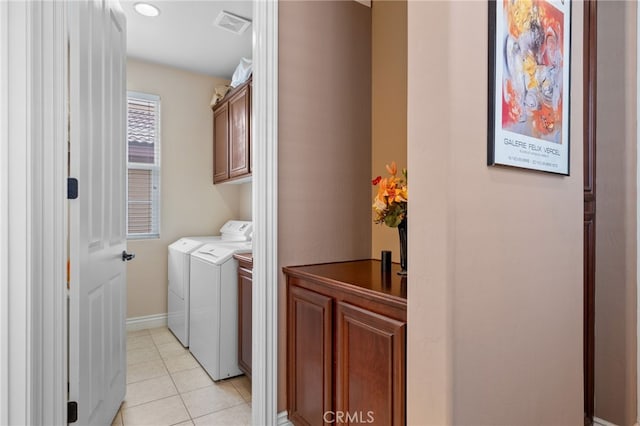 5206 Village Green Ln, Bakersfield, CA 93306 - washroom with cabinet space, washer and clothes dryer, light tile patterned floors, and baseboards