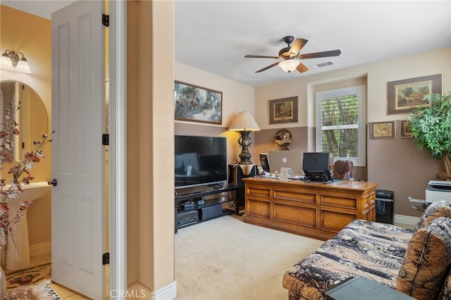 bedroom featuring a ceiling fan, visible vents, and light carpet