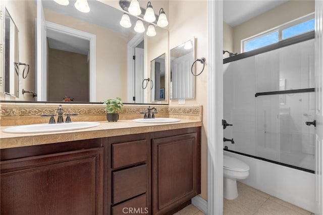 bathroom featuring tile patterned flooring, a sink, double vanity, and toilet