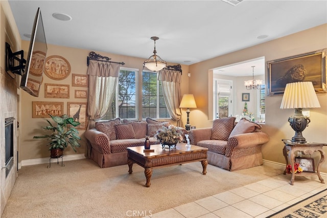 5206 Village Green Ln, Bakersfield, CA 93306 - carpeted living room featuring a chandelier, baseboards, tile patterned floors, and a glass covered fireplace