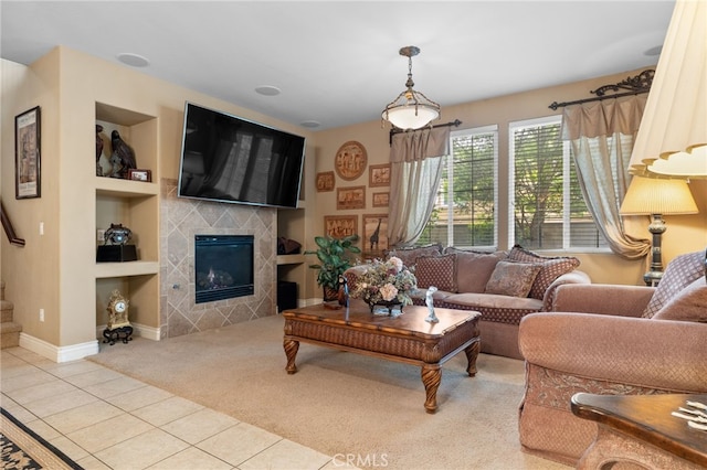 living area with tile patterned flooring, carpet, built in shelves, a fireplace, and baseboards
