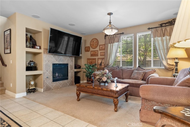 5206 Village Green Ln, Bakersfield, CA 93306 - tiled living room with carpet floors, built in features, baseboards, a tiled fireplace, and stairway